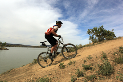 A racer hill climbs at 18 Hours of Fruita.