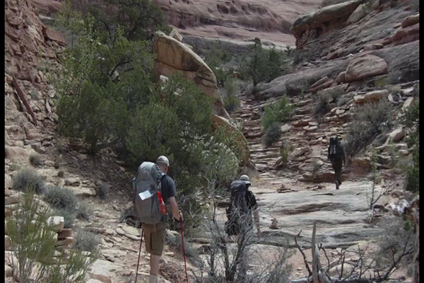 Hikers ascend the rocks at Big Spring in Canyonlands National Park.
