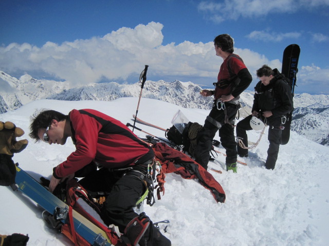 Gearing up and eating lunch on top of the Pfeifferhorn. Skiers: Justin Lozier, Adam Symonds and Chad Burt.