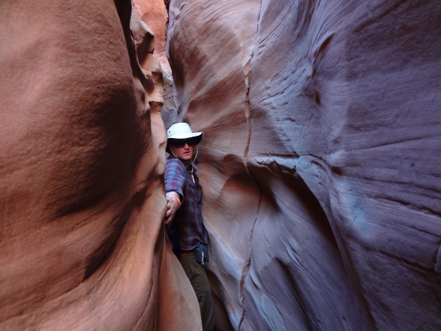 Hiker Todd Dinsmore negotiates the narrow walls in Spooky Gulch slot canyon. (Photo: Ryan Malavolta - UtahOutside.com)