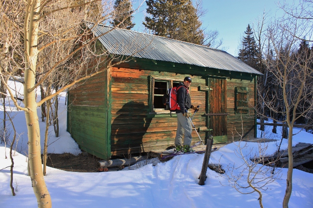 Adam Symonds checks out an old cabin near the shore of Puffer Lake. (Photo: Jared Hargrave - UtahOutside.com)