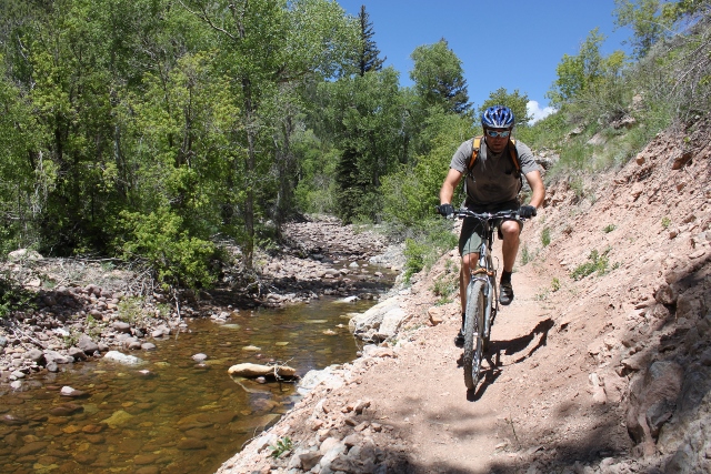 Adam Symonds rides a new section of cut trail along Dry Fork Creek. (Photo: Jared Hargrave - UtahOutside.com)