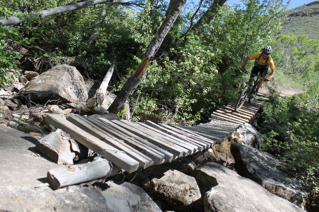 Although the Flume Trail is mostly intermediate riding, there are some scary parts, like crossing this rickety bridge. (Photo: Jared Hargrave. Rider: Mike DeBernardo)