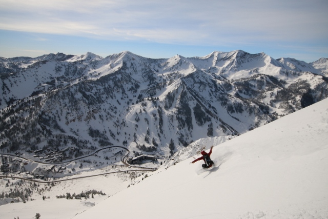 Jon Gilchrist snowboards above Snowbird and Alta on the south slopes of Little Superior. (Photo: Jared Hargrave - UtahOutside.com)