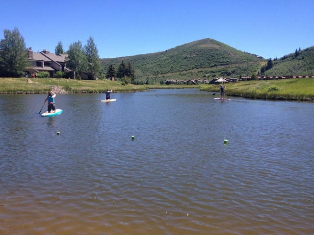 The author, along with Daniel and Rebecca Kelley, get their lake legs under them at Deer Valley's Pebble Beach on Park City SUP paddleboards. (Photo: Callista Pearson - UtahOutside.com)
