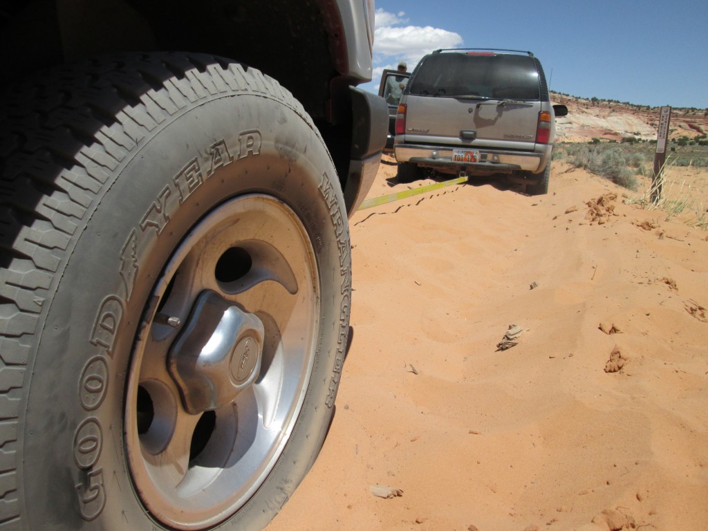A local guide offers a tow line to our vehicle. We got our truck stuck no less than 5 times in the deep sand of the Vermillion Cliffs area. (Photo: Ryan Malavolta)