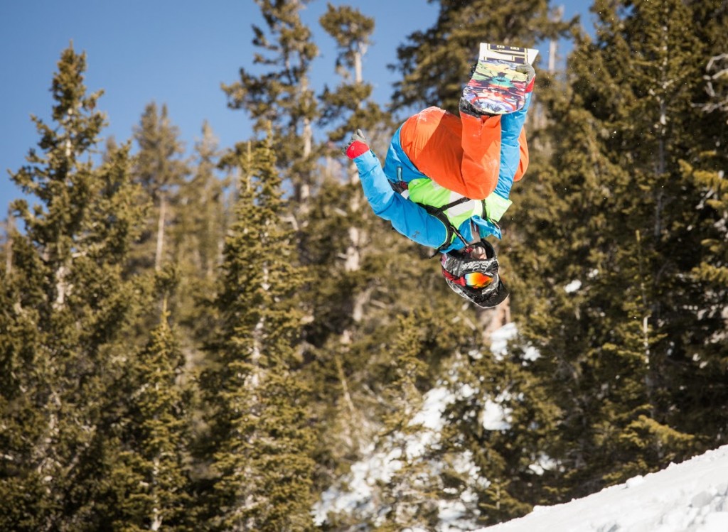 A snowboarding competitor gets inverted at the Subaru Freeride Series at Snowbird.