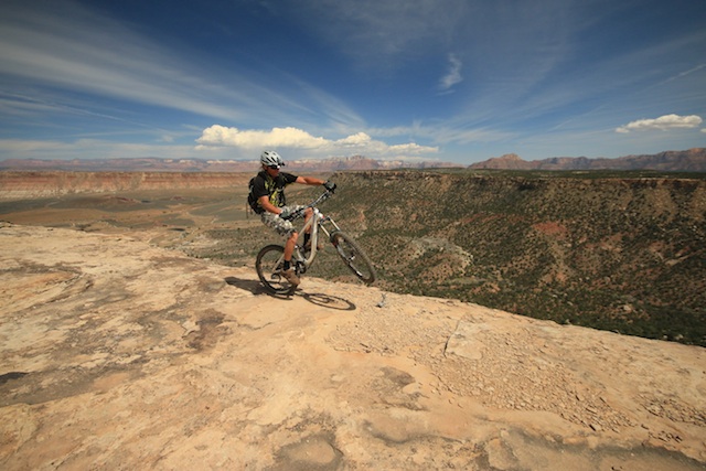 Over the Edge riding on the Edge - views abound at the end of the Point Loop on Little Water with Zion National Park in the distance. (Photo: Jared Hargrave - UtahOutside.com)