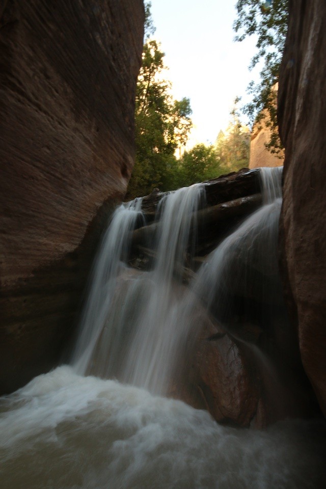The Zion Narrows waterfall is pretty, but dangerous. Instead of going over it, hike through the slot to the side of the falls. (Photo: Jared Hargrave - UtahOutside.com) 